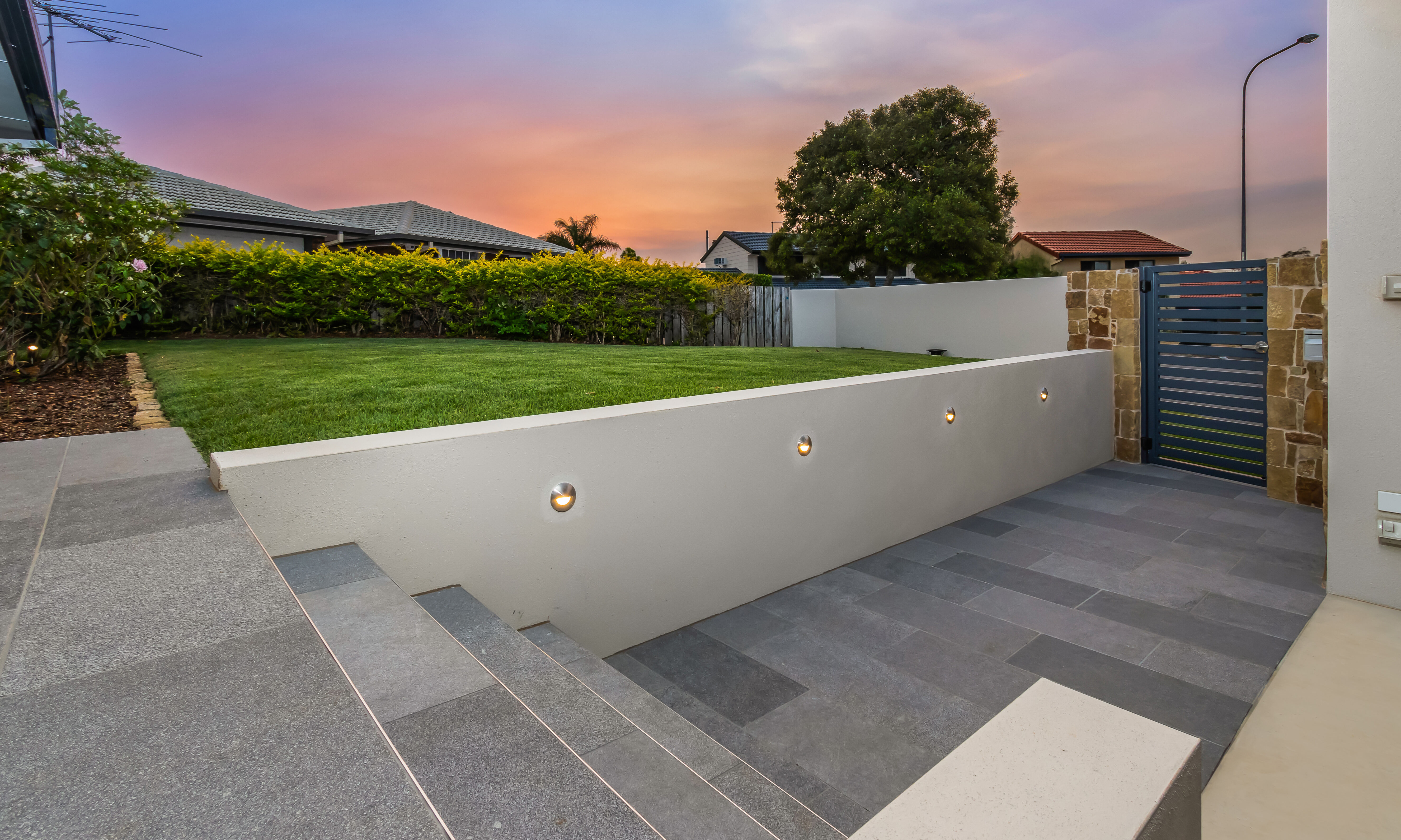 Tiled entry pathway and entry steps with feature lighting 