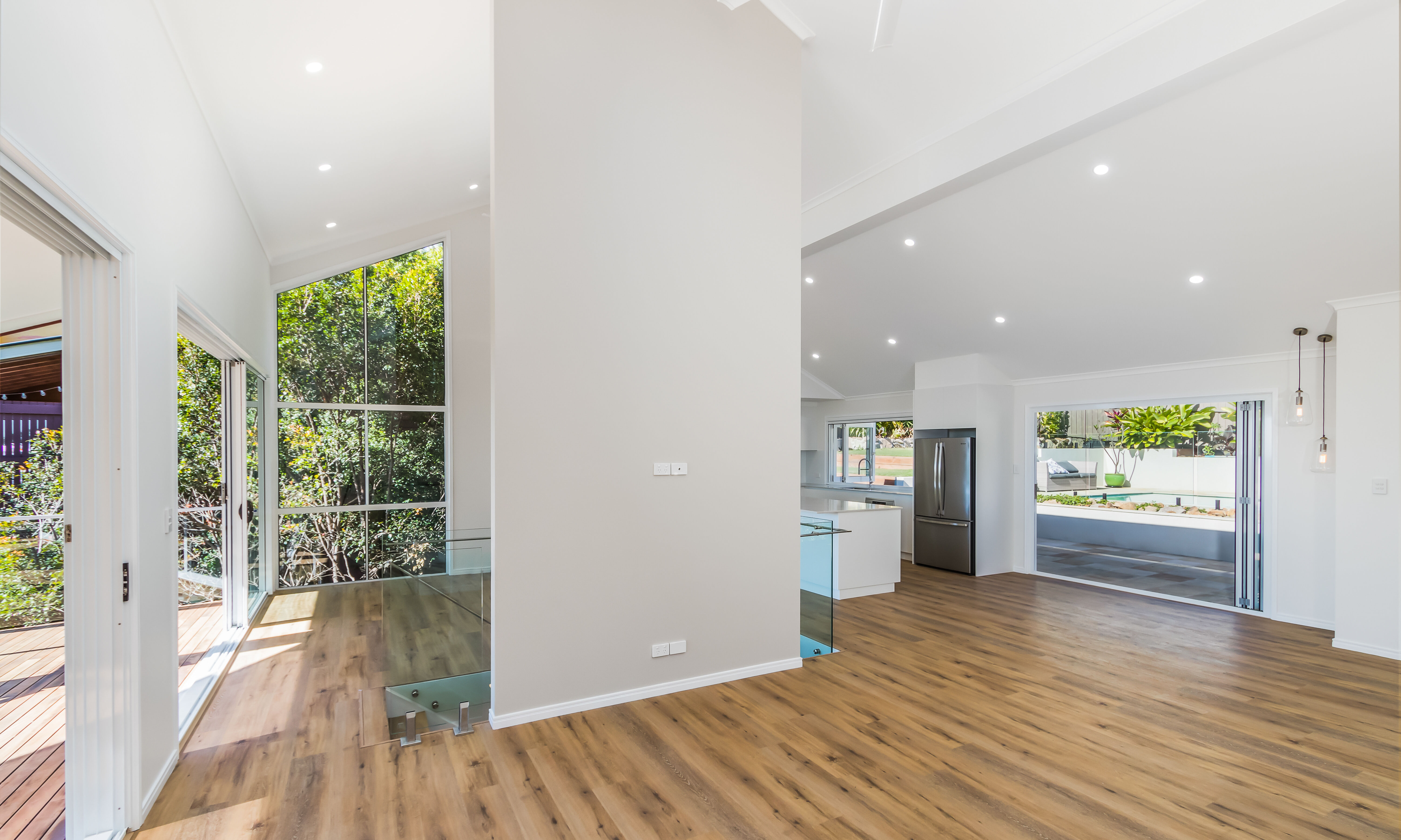 Open plan living area-pool-timber floors