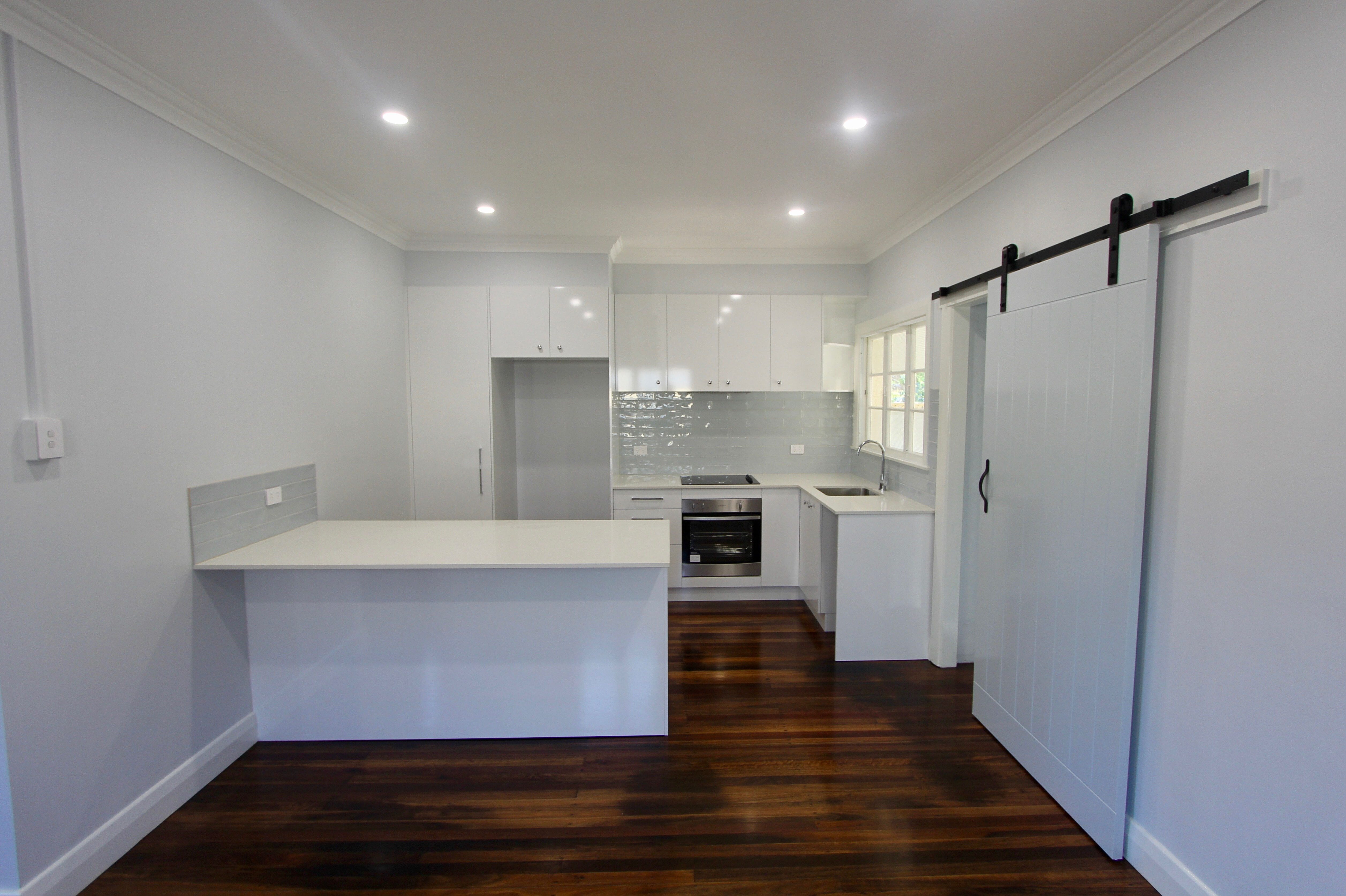 Kitchen renovation-subway tiles-timber flooring-white cabinets