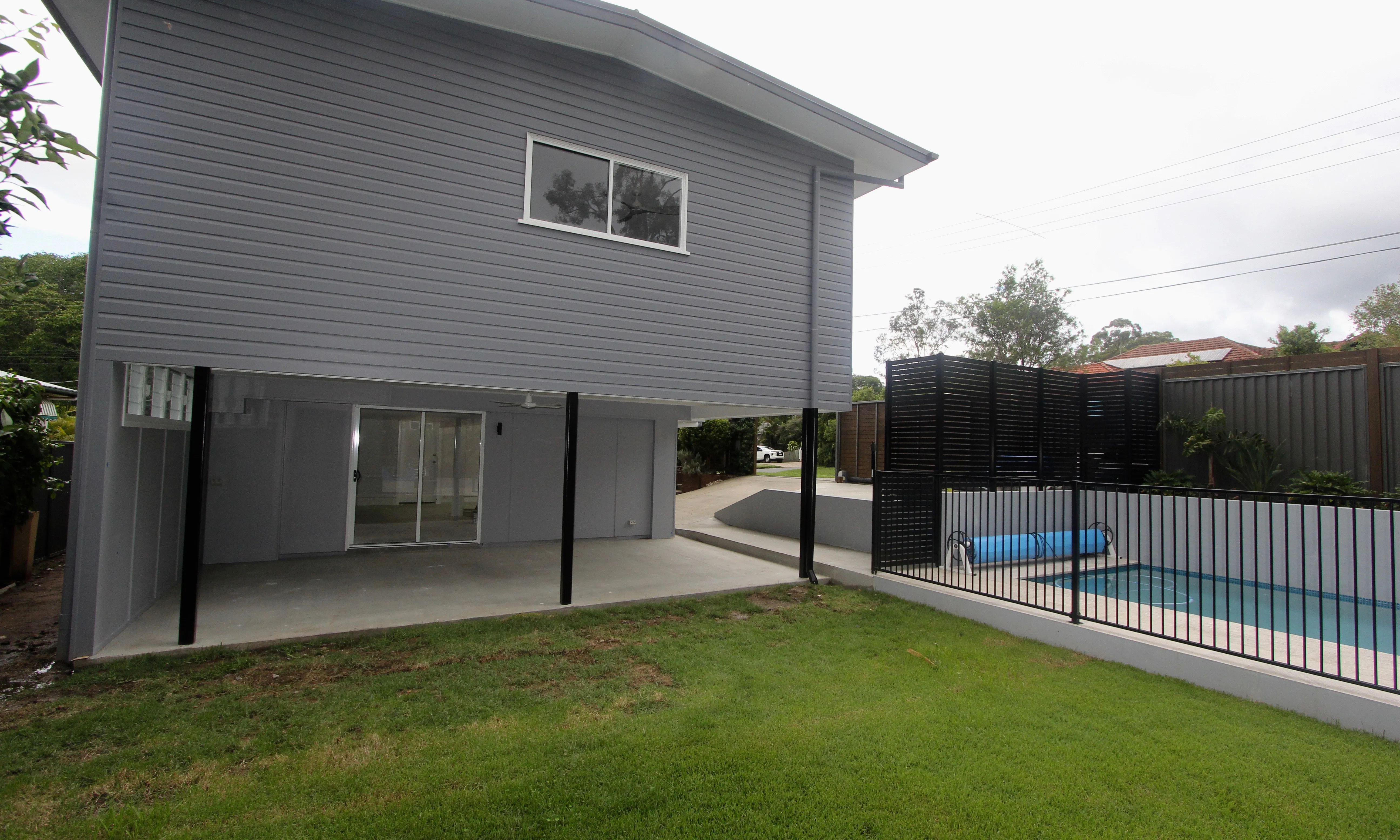 Back yard with large pool and powder coated pool balustrade 