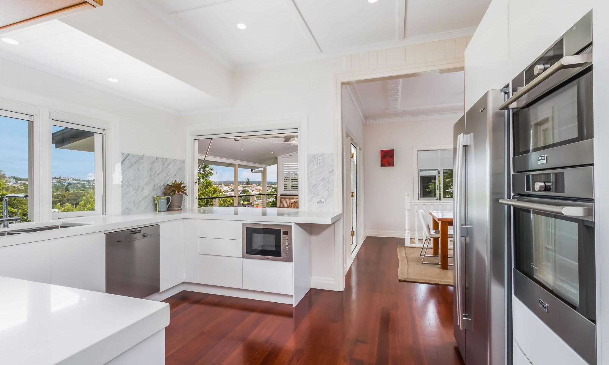 kitchen-marble-gas strut window-renovation-white cabinets-timber floors