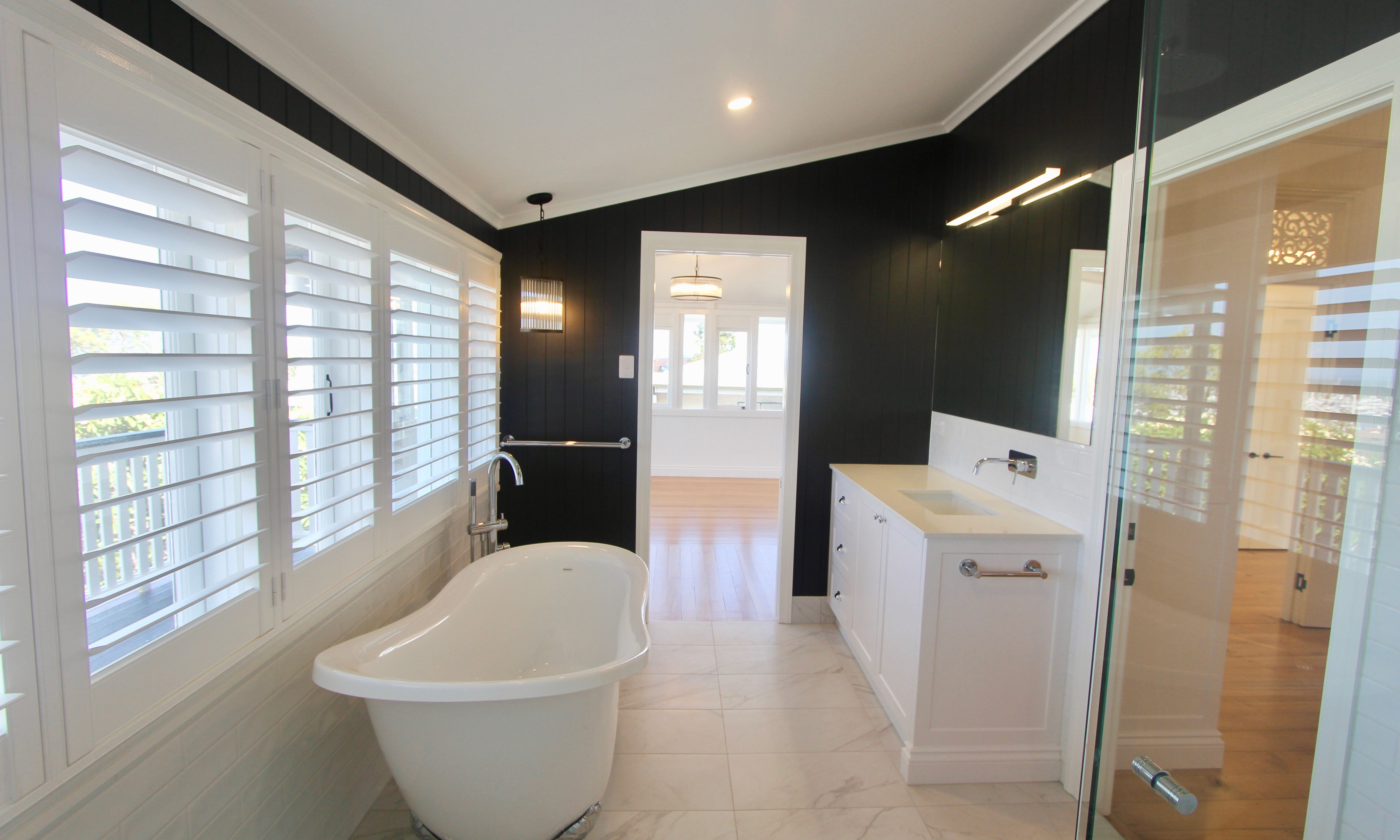 Clawfoot bath in black and white bathroom