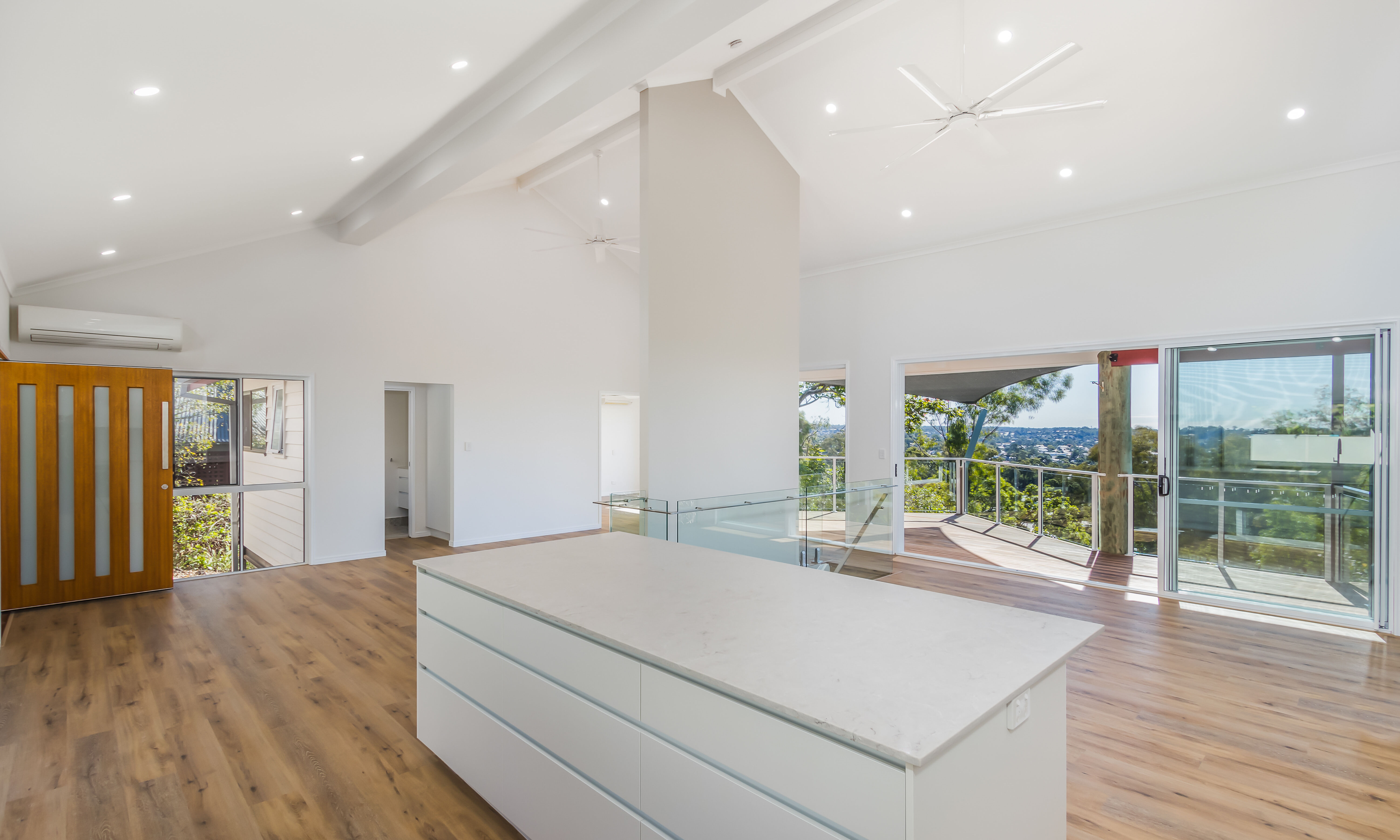 Kitchen island and deck-timber entry door-open plan living